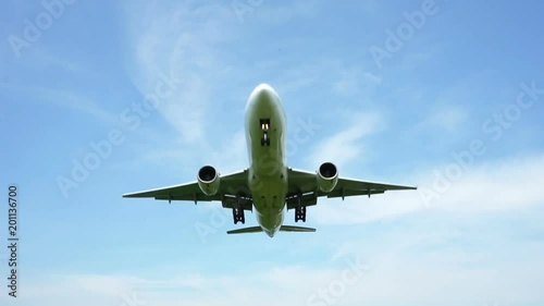 Jet plane approaching landing across blue sky
