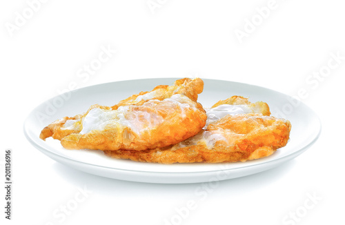 Fried eggs in white plate on white background