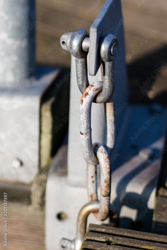 Naklejka premium Steel construction used at bridges. Szekla and the chain maintaining the gangway in the marina.