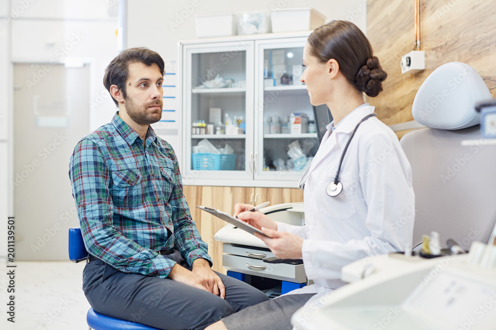 Male patient listening to the doctor at the hospital