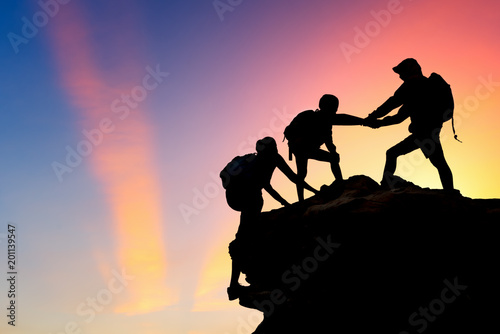 Silhouette of a group people to the mountain climbing