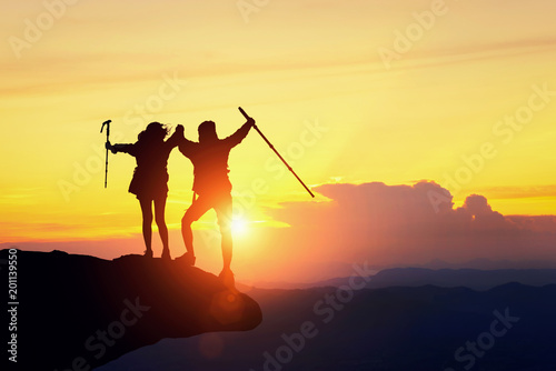 silhouette of backpacker hiking on sunset mountain peak