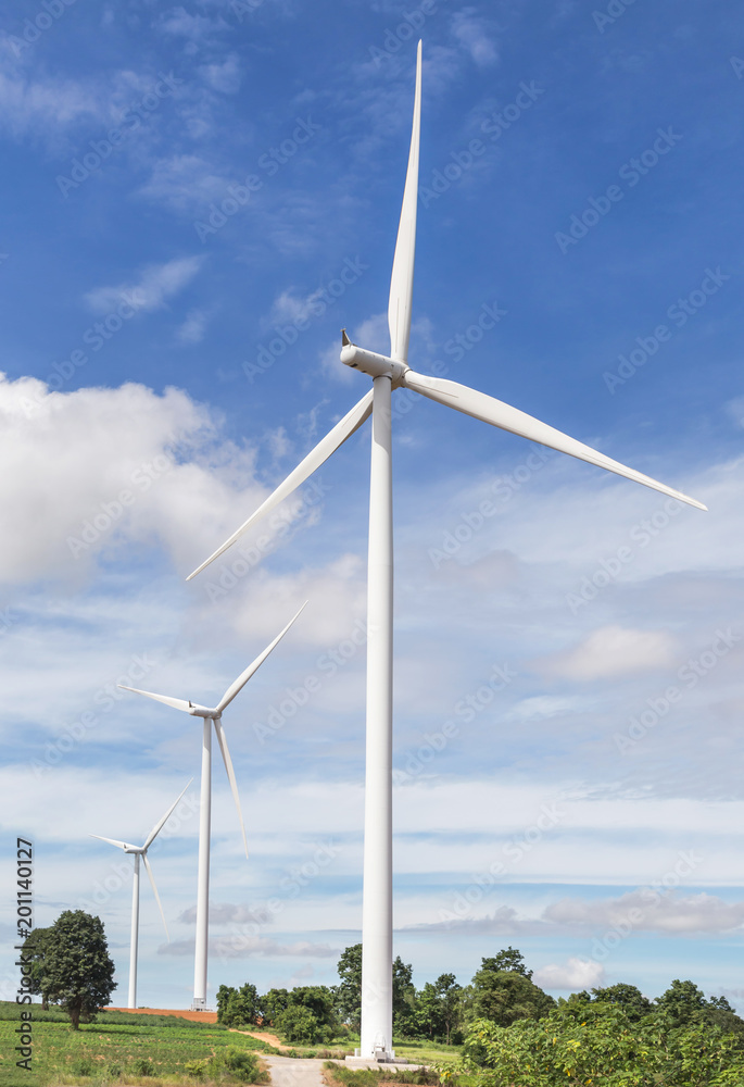 white wind turbines generating electricity in wind power station alternative renewable energy from nature under blue sky background white wind turbines generating electricity in wind power station alternative renewable energy from nature under blue sky background
