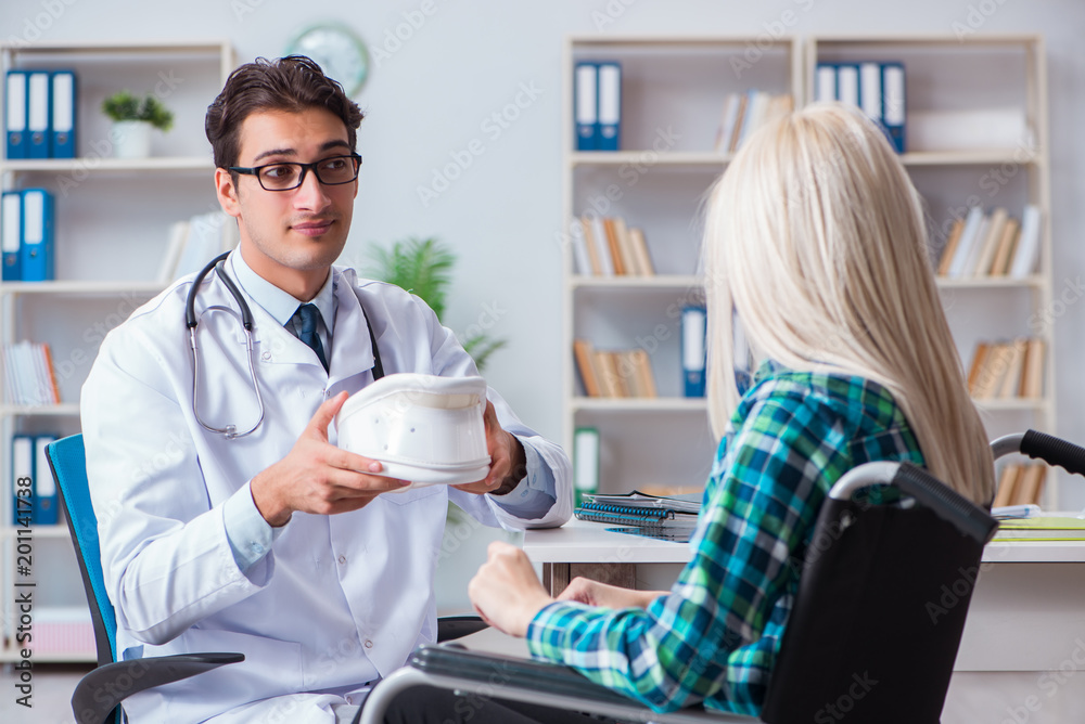 Fototapeta premium Disabled woman in wheel chair visiting man doctor