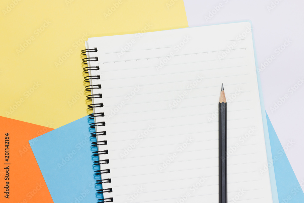 Book and pen placed on colored paper. Book and pen placed on colored paper.