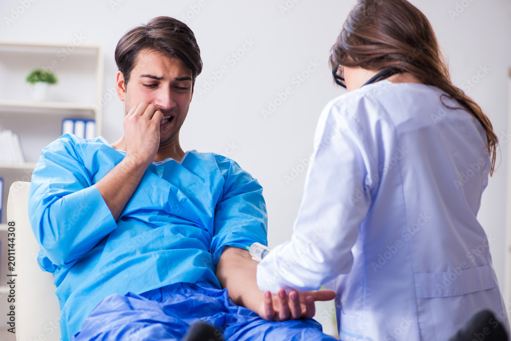 Scared patient man getting ready for flu shot Scared patient man getting ready for flu shot