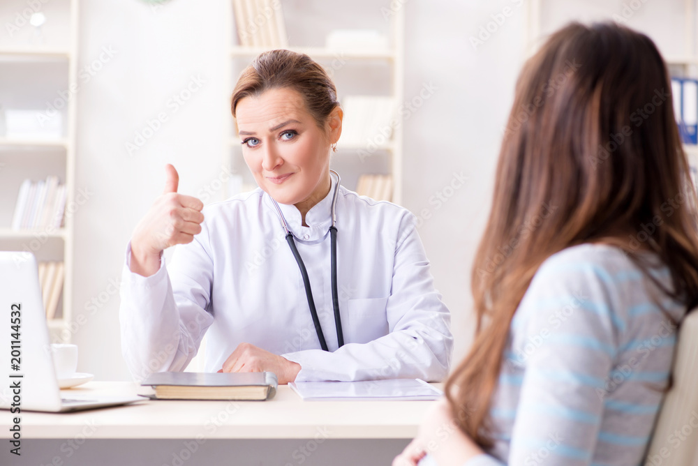 Pregnant woman visiting doctor for regular check-up Pregnant woman visiting doctor for regular check-up