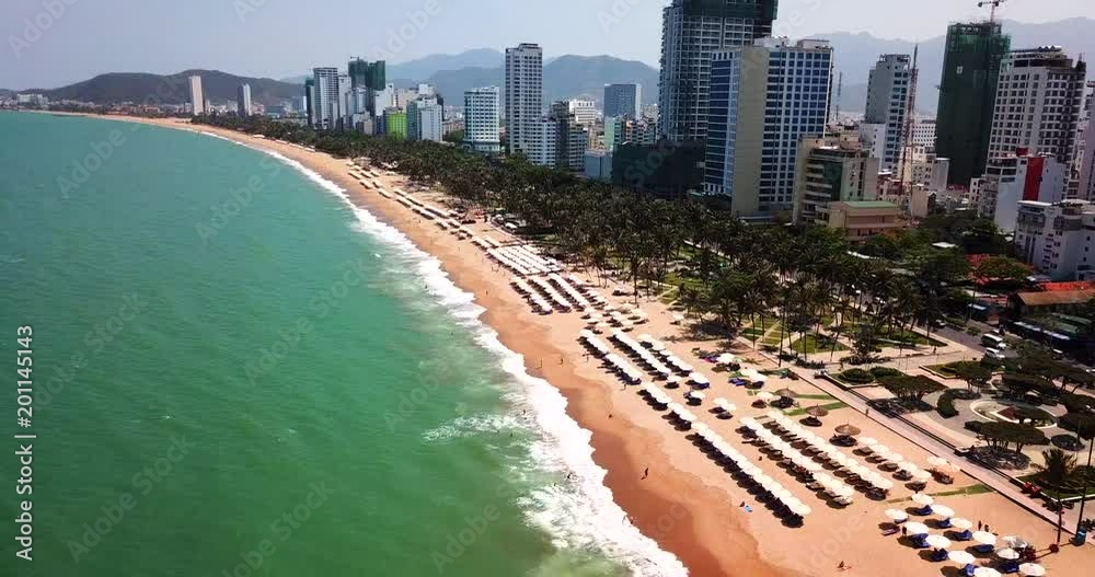 AERIAL 4K:  view on the resort sand beach line in Nha Trang city- Central Vietnam