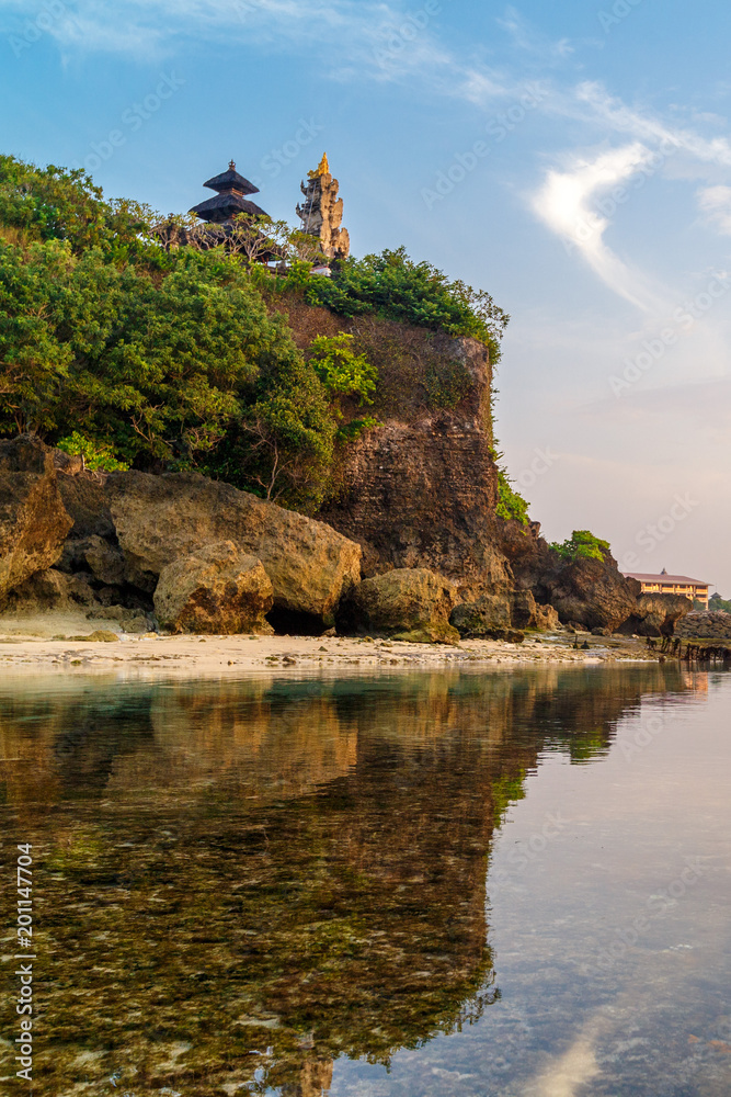 Geger beach and Pura Geger in Nusa Dua, Bali, Indonesia. Tradition Balian temple on cliffe over water