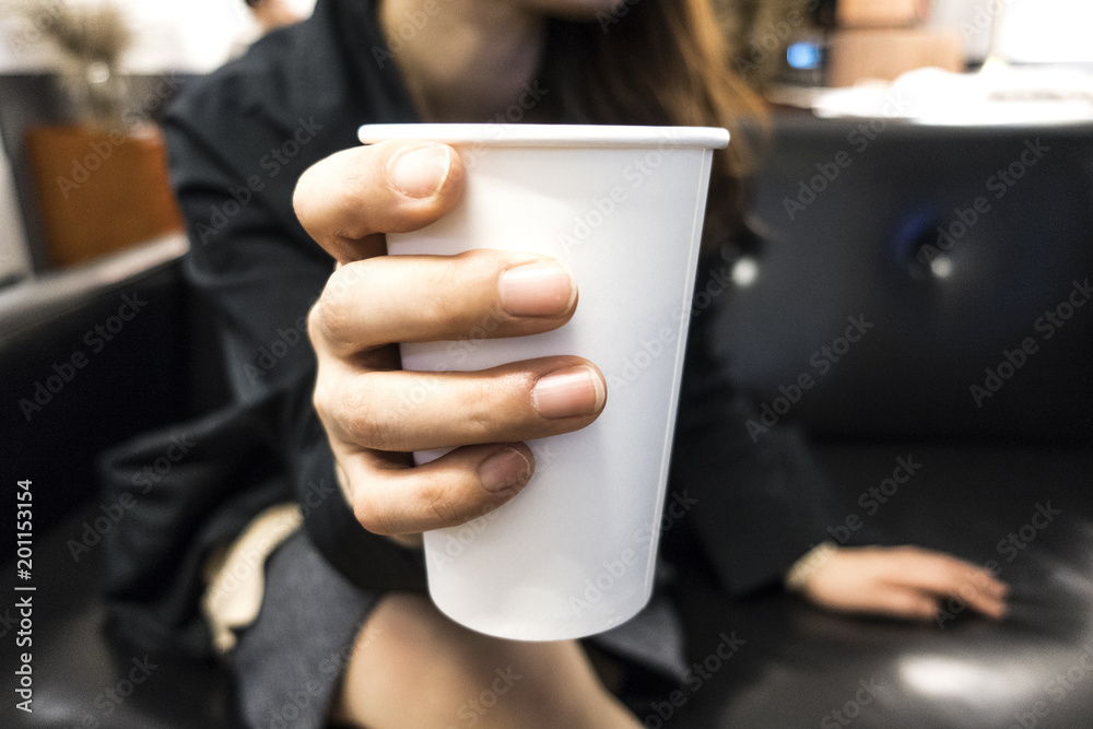 close up of woman hands holding cup of coffee