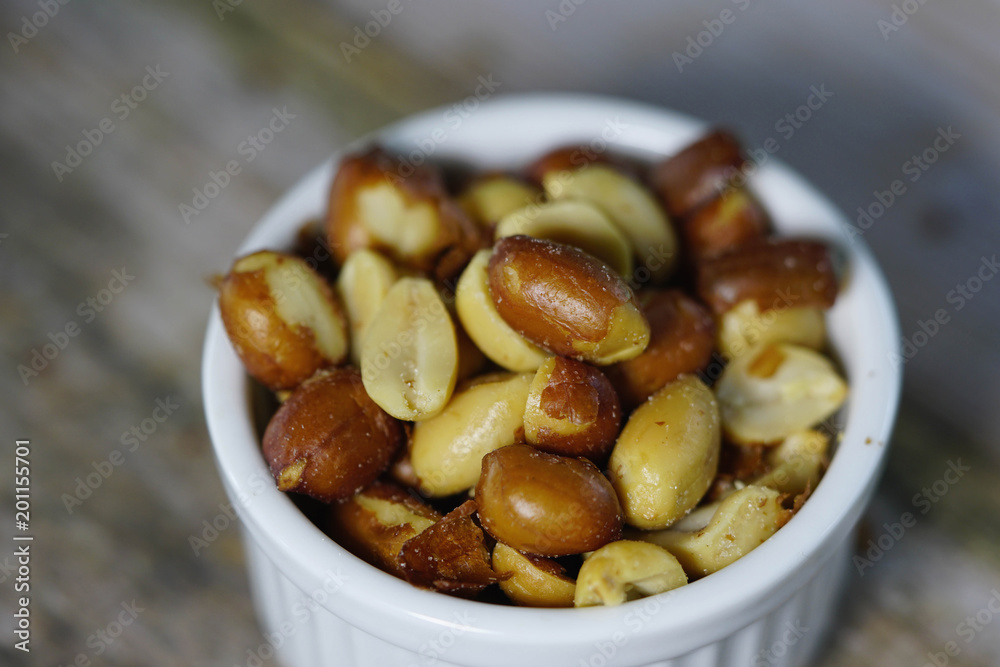 peanuts or beer nuts in a white bowl on the table peanuts or beer nuts in a white bowl on the table