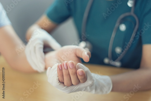 Doctor hand Physicist physical therapy treatment patient in the clinic.Orthopedic medical exam in doctor's hospital office Partnership, traumatology and medical consultation for hand wrist injury photo