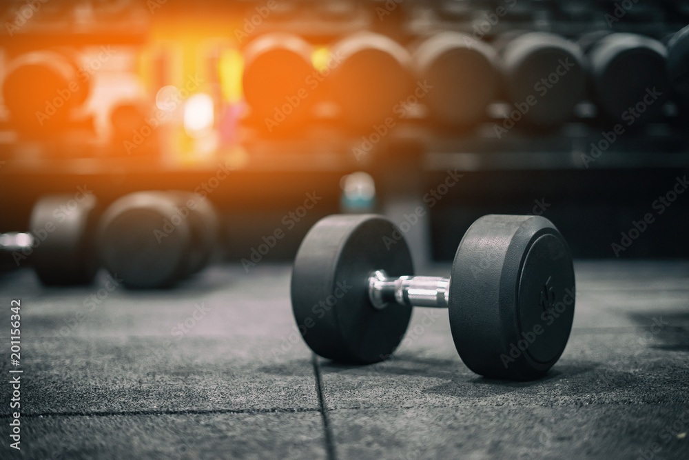 Gym and dumbbell weight training equipment on sport ,Healthy life and gym exercise equipments and sports concept ,copy space Gym and dumbbell weight training equipment on sport ,Healthy life and gym exercise equipments and sports concept ,copy space
