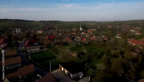 Aerial drone footage of countryside village houses in late afternoon lights. Manastireni, Transylvania, Romania photo