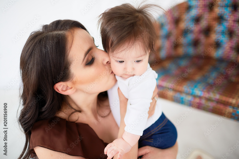The mother embarcing her daughter and standing in the room The mother embarcing her daughter and standing in the room