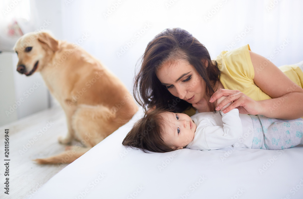 The mother embrace her daughter and lie on the bed The mother embrace her daughter and lie on the bed