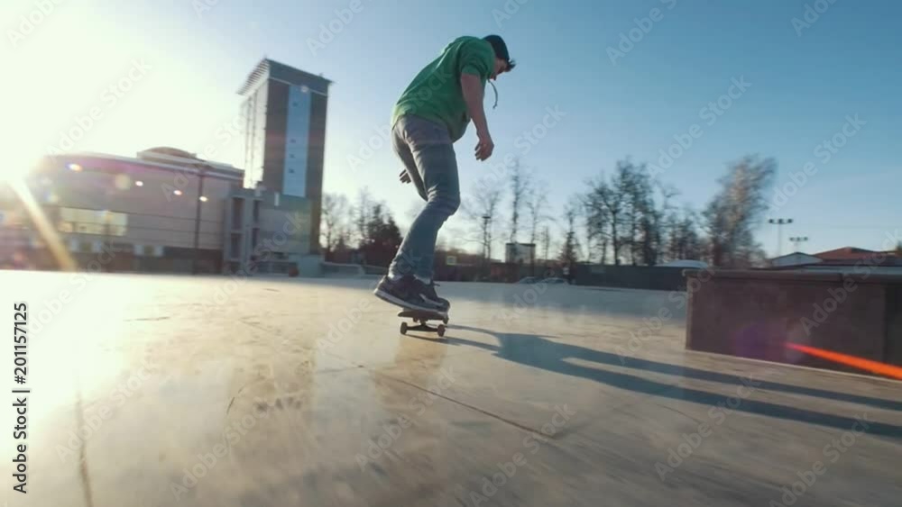 Young man riding on skateboard at the on the city street
