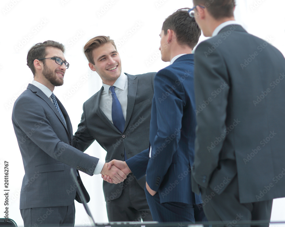 Successful business people shaking hands in an office. Successful business people shaking hands in an office.