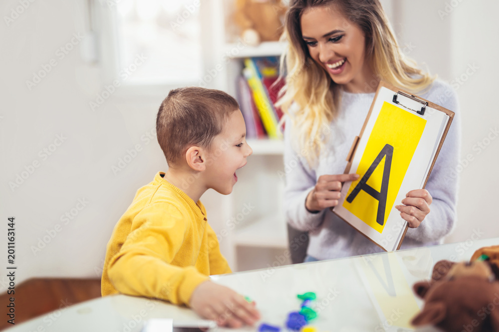 Speech therapist teaches the boys to say the letter A Speech therapist teaches the boys to say the letter A