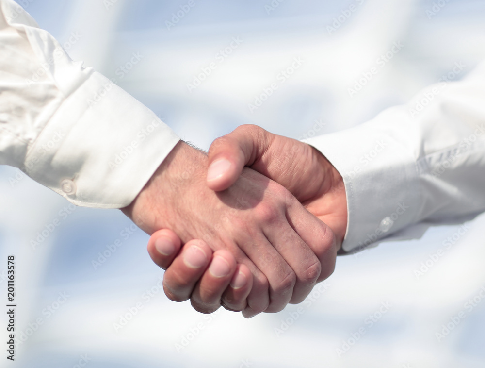 Close-up photo of handshake of two successful businessmen Close-up photo of handshake of two successful businessmen