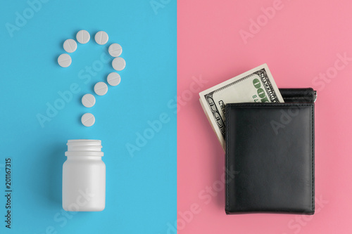 Pharmaceutical pills, hundred dollar bill and bottle on blue magenta background. Concept question mark, cost of treatment.
