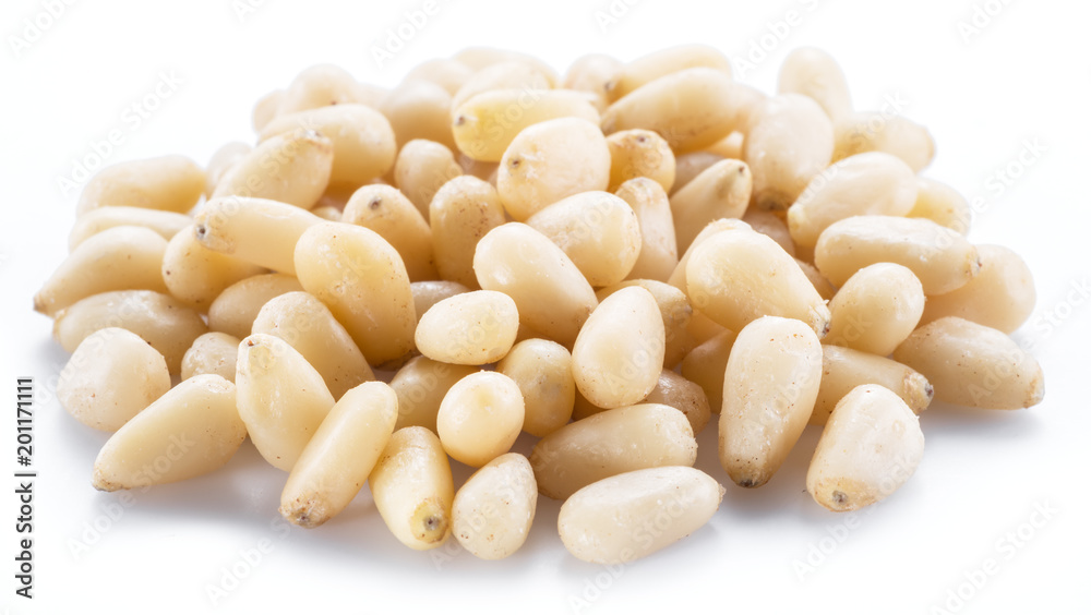 Pine nuts on the white background. Organic food. Pine nuts on the white background. Organic food.