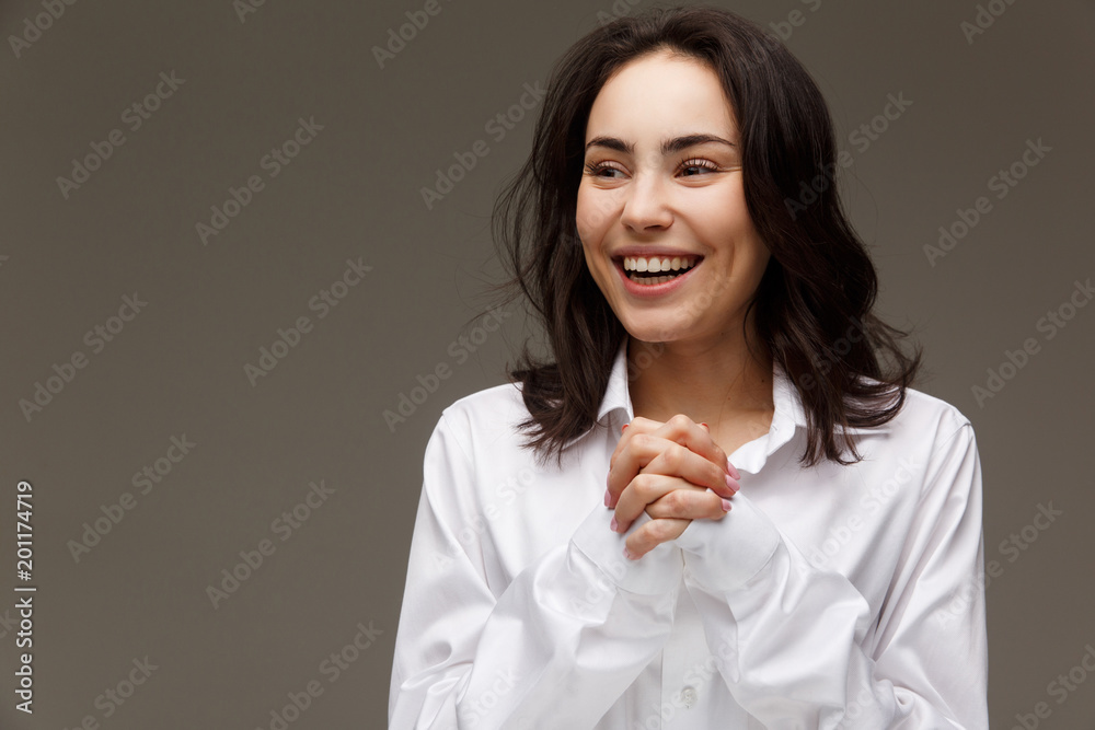 Beautiful girl in a white shirt shows emotions - smile, fun. Beautiful girl in a white shirt shows emotions - smile, fun.
