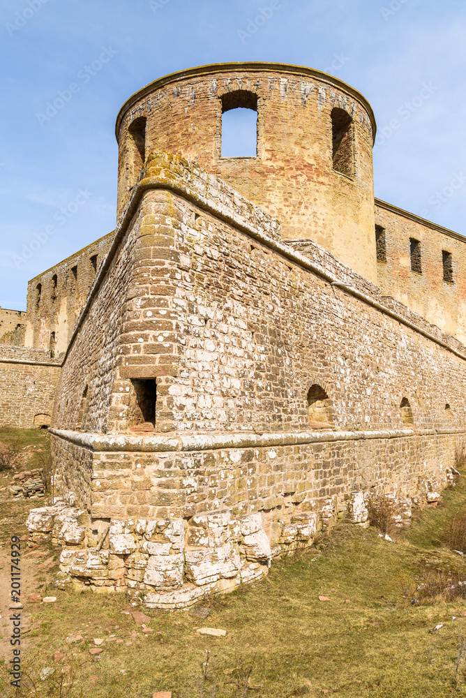 Historic castle ruin at Borgholm, Oland in Sweden. A corner of the perimeter wall and a tower seen from the outside. A popular travel destination with historic values.