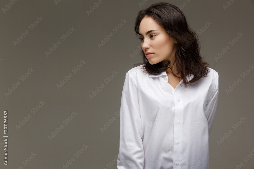Beautiful girl in a white shirt shows emotions. Beautiful girl in a white shirt shows emotions.