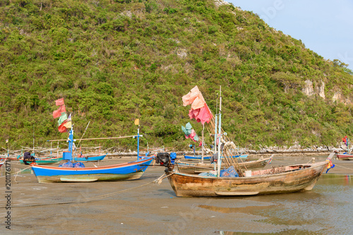 Fishing boats aground on the beach over sunny sky at Prachuap Khiri Khan  Thailand.