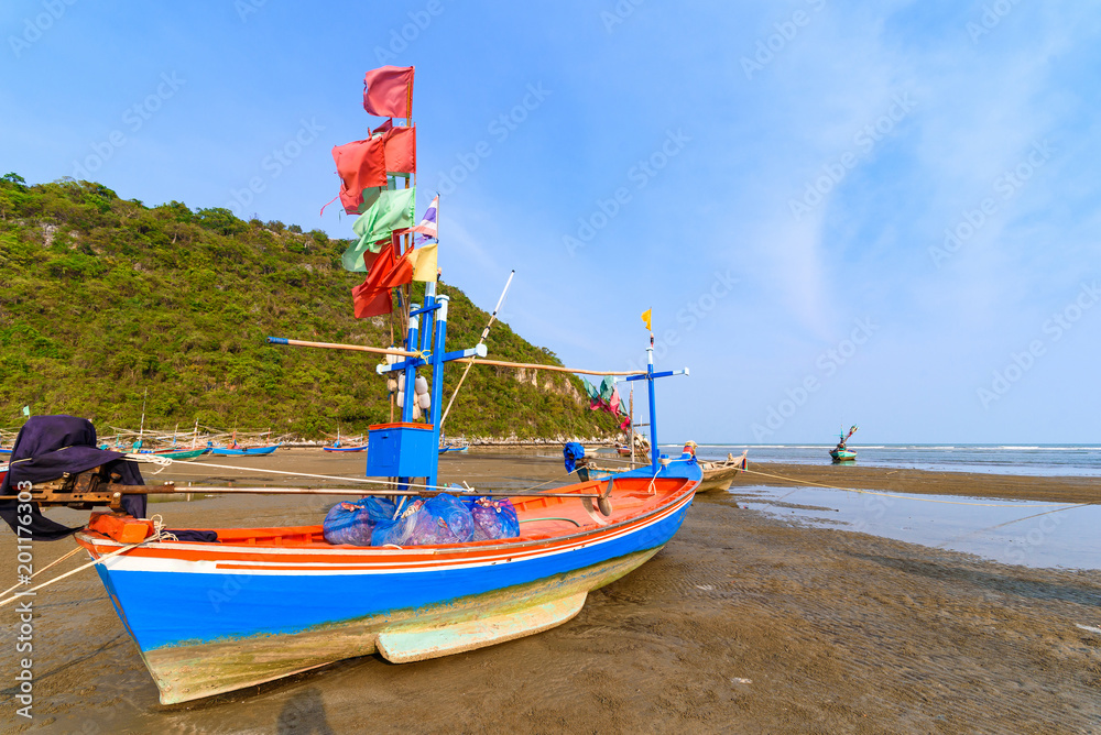 Fototapeta premium Fishing boats aground on the beach over sunny sky at Prachuap Khiri Khan, Thailand.