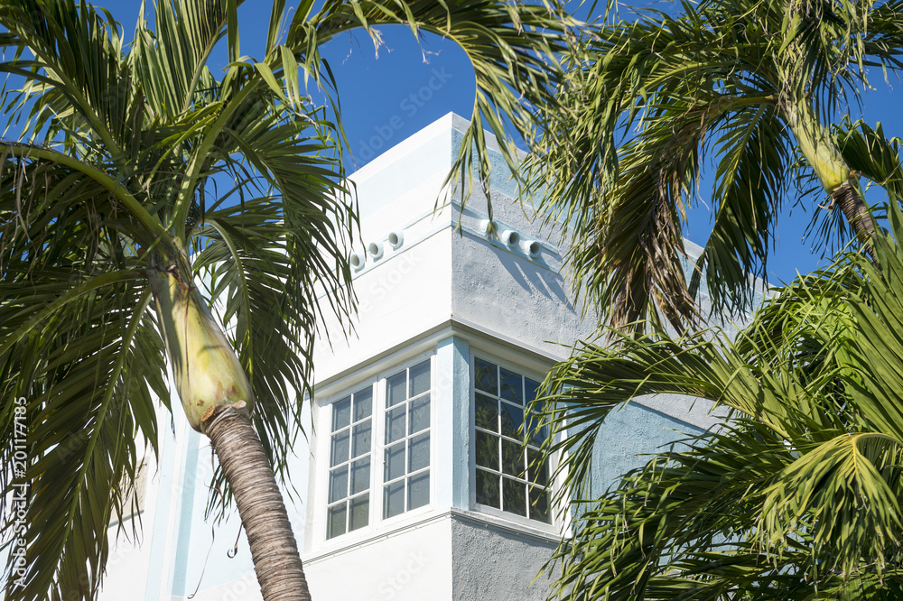 Typical colorful Art Deco architecture with palm trees in South Beach, Miami, Florida