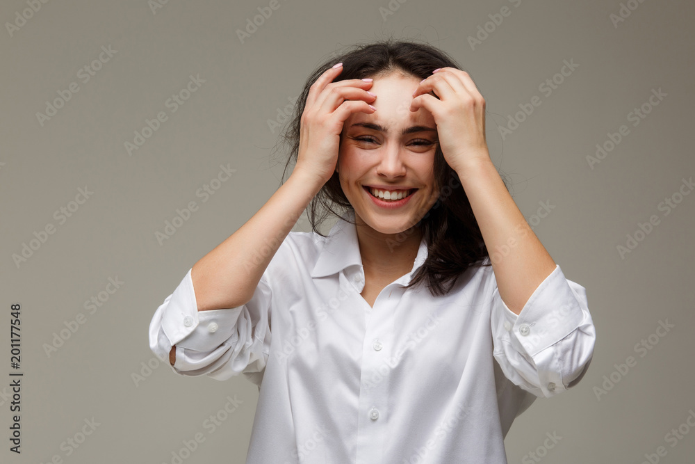 Beautiful girl in a white shirt shows emotions - smile, fun. Beautiful girl in a white shirt shows emotions - smile, fun.