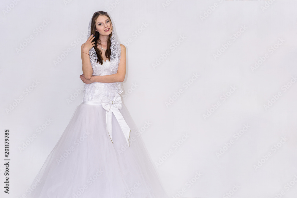 beautiful bride in white wedding dress in different poses on white backgrounds shows different emotions