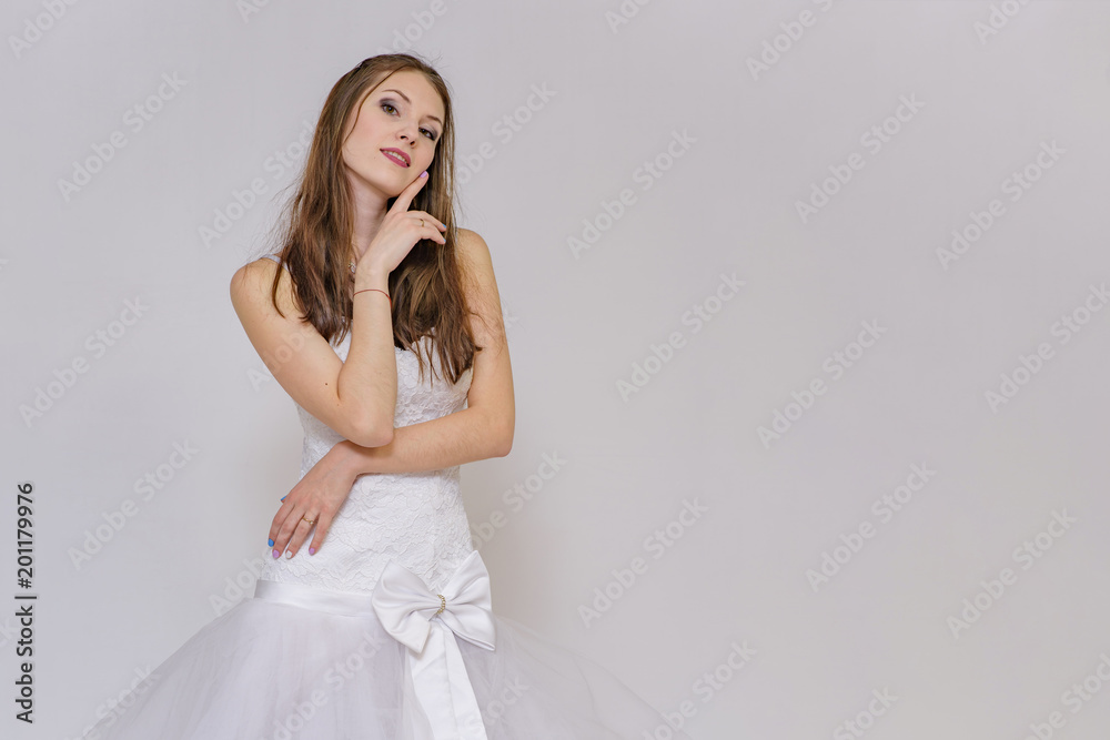 beautiful bride in white wedding dress in different poses on white backgrounds shows different emotions