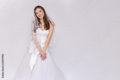 beautiful bride in white wedding dress in different poses on white backgrounds shows different emotions