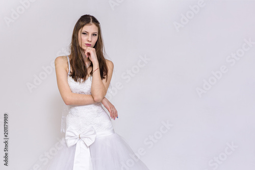 beautiful bride in white wedding dress in different poses on white backgrounds shows different emotions