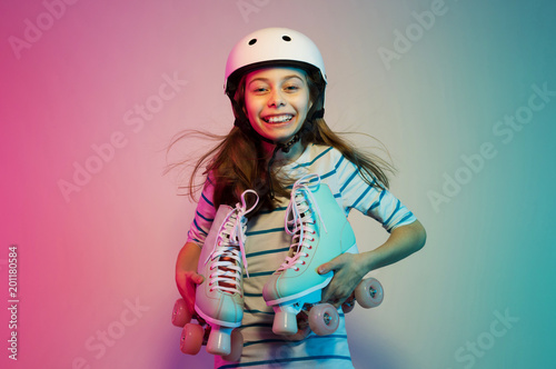 Young child girl in safety helmet with roller skates - sports