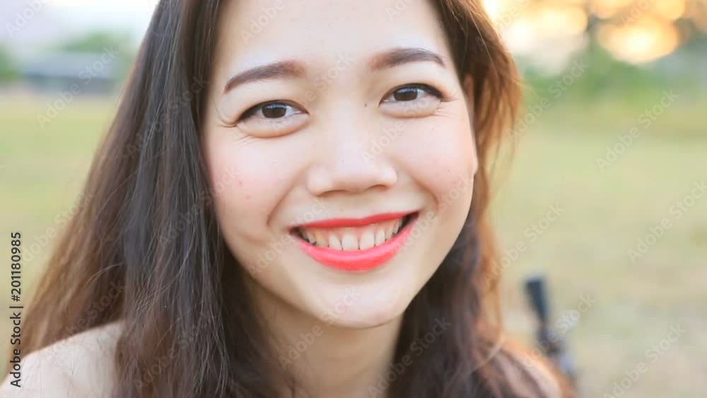 close up toothy smiling face of younger asian woman close up toothy smiling face of younger asian woman