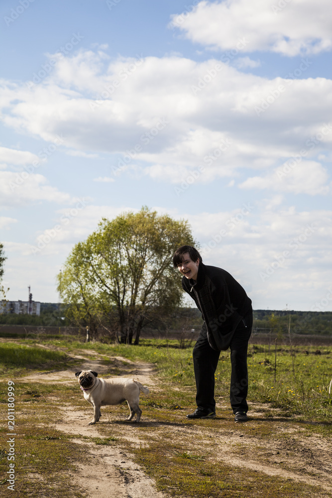 Obraz premium Teenager walks with a dog