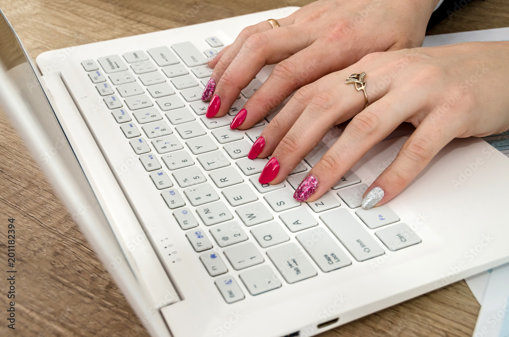 Hands of a woman on a laptop keyboard Hands of a woman on a laptop keyboard
