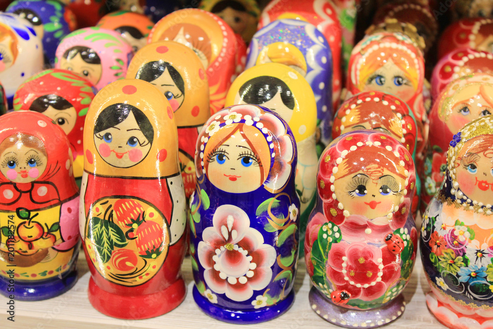 Russian Matryoshka Nesting Dolls Set in Classic Clothes at Gift Shop Shelf. Stacking Women Figures Made of Wood and Painted in Various Colors is a Traditional Souvenir from Russia.