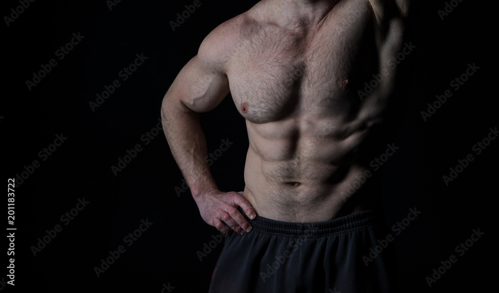 Torso with six pack and ab muscles. Arm with strong biceps and triceps. Athletic belly and muscular chest. Workout and training activity in gym. Sport fitness and wellness concept Torso with six pack and ab muscles. Arm with strong biceps and triceps. Athletic belly and muscular chest. Workout and training activity in gym. Sport fitness and wellness concept