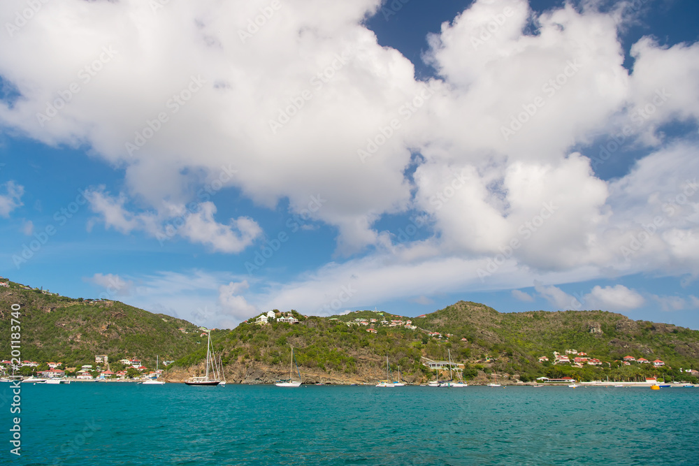 Summer vacation on tropical island. Mountain shore in blue sea on cloudy sky in gustavia, st.barts. Wild nature and environment, ecology. Holiday destination while travelling and wanderlust