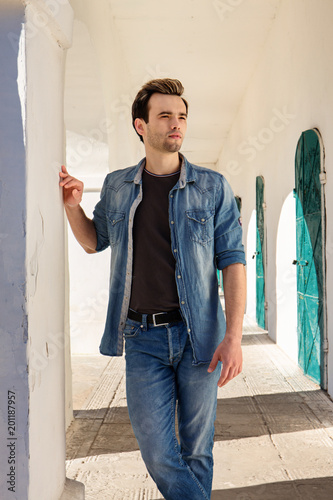 man in jeans trousers and shirt photo