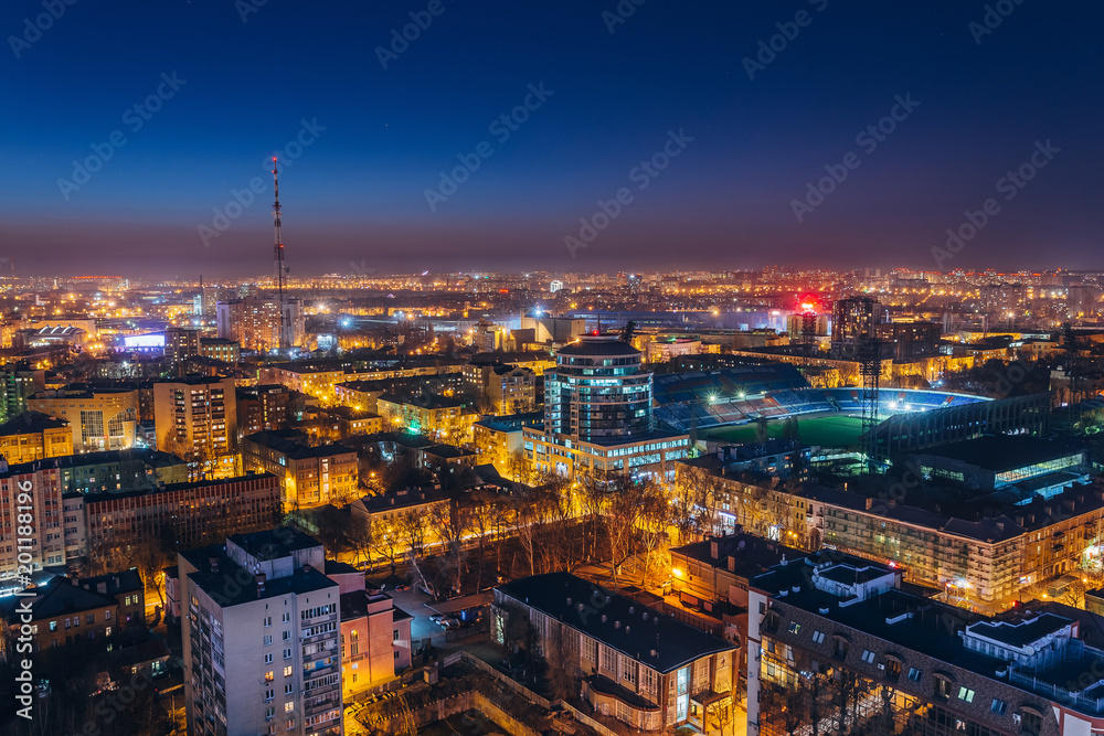 Aerial view of night Voronezh downtown. Voronezh cityscape at blue hour. Urban lights, modern houses, television tower, stadium - obrazy, fototapety, plakaty 