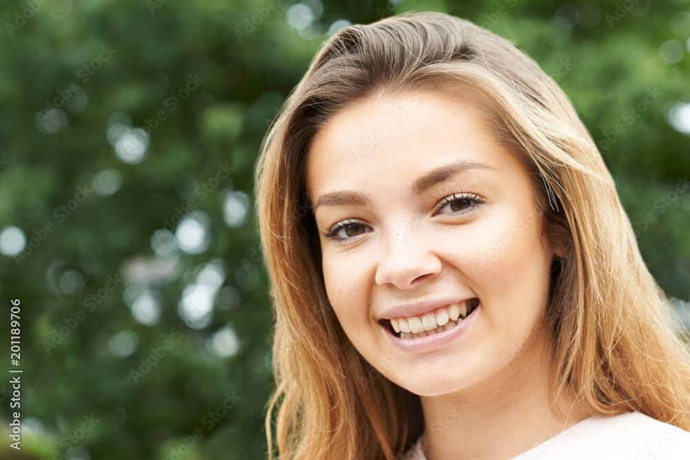 Head And Shoulders Portrait Of Smiling Teenage Girl