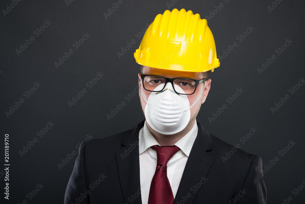 Business young man wearing hardhat and protection mask. Business young man wearing hardhat and protection mask.
