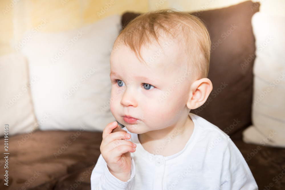Happy smiling kid boy eating tasty chocolate Happy smiling kid boy eating tasty chocolate