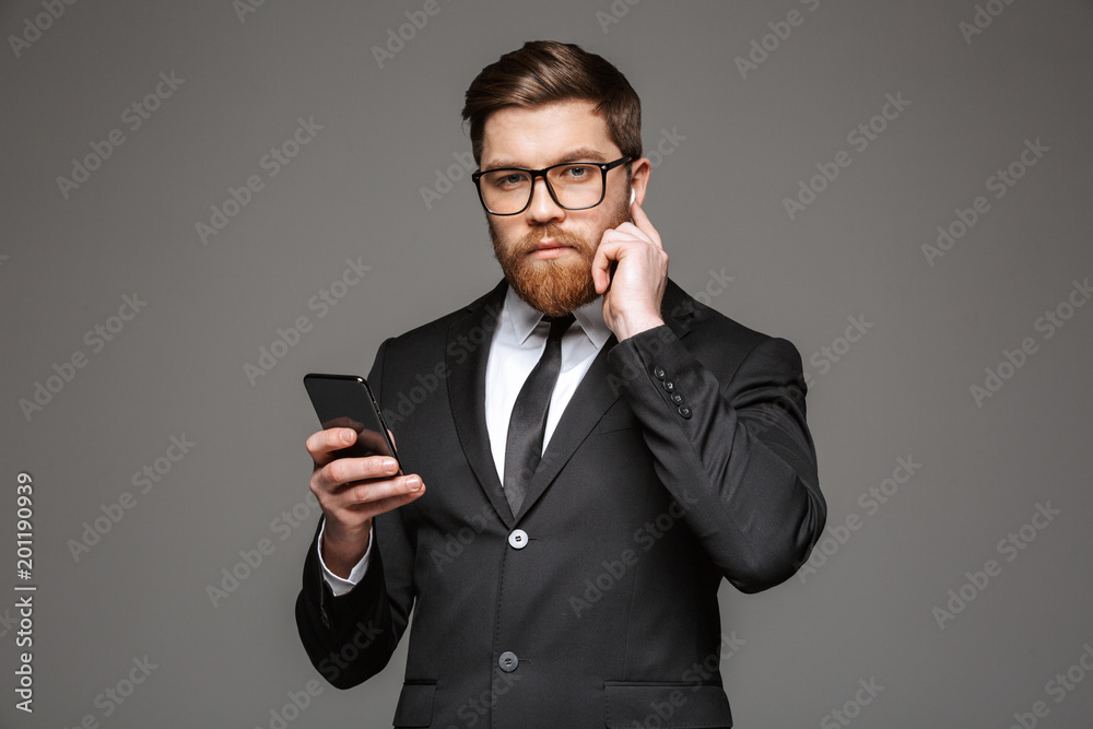 Portrait of a confident young businessman in earphones Portrait of a confident young businessman in earphones